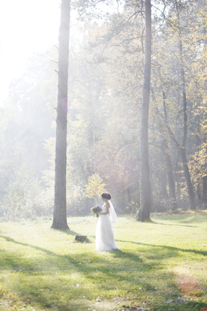 beautiful woman in the morning mist in autumn forestの写真素材