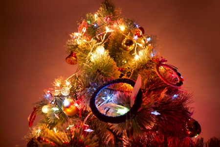 A christmas tree with christmas tree lights in the dark.の写真素材