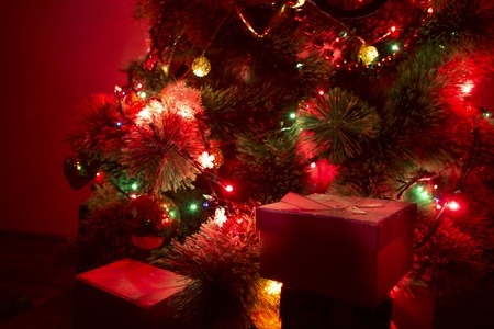 A christmas tree with christmas tree lights in the dark.の写真素材
