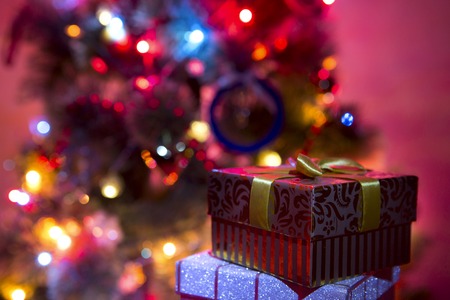 christmas lights hanging in a tree creating a wonderful bokeh of lightsの写真素材
