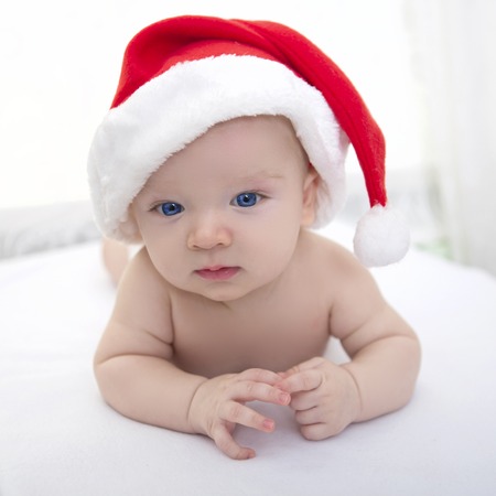 portrait of a baby boy, beautiful funny infant in Santa's hatの写真素材
