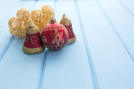 wood board table in front of Christmas warm gold garland lights on wooden rustic background.の写真素材