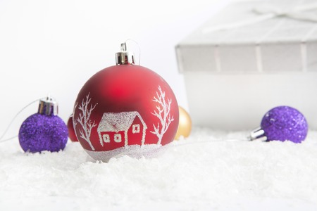 Decorated Christmas gifts in snow on white backgroundの写真素材