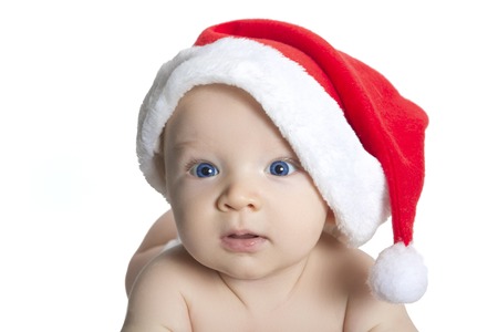 cute baby boy wearing christmas cap, beautiful funny infant in Santa's hatの写真素材