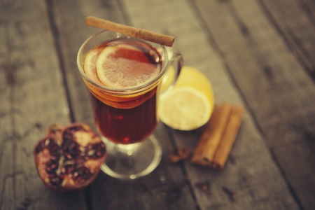 Mulled wine with spices on a wood tableの写真素材