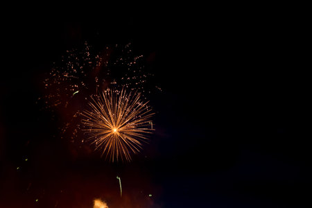 Beautiful colorful holiday fireworks in the evening sky with majestic clouds,  long exposure
