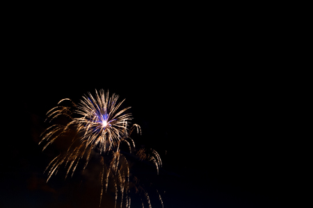 Beautiful colorful holiday fireworks in the evening sky with majestic clouds,  long exposureの写真素材