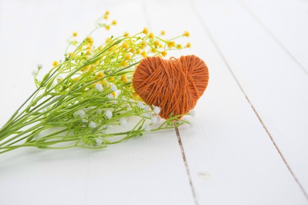 Handmade crochet heart for decoration and greetings card with skein on wooden table. Selective focus. Valentine's Dayの写真素材