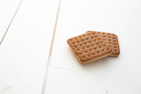 Stack of square crackers on the white wooden table backgroundの写真素材