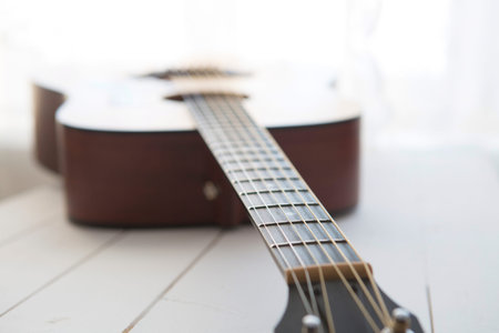 Acoustic guitar  on the white wooden table background