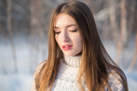 Winter portrait of a beautiful brunette. Joyful Beauty young woman Having Fun in Winter Park.の写真素材