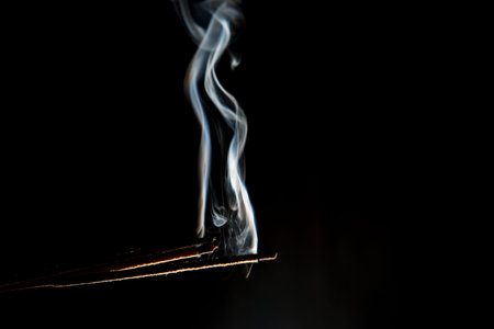 White smoke from aromatic stick on dark or black background