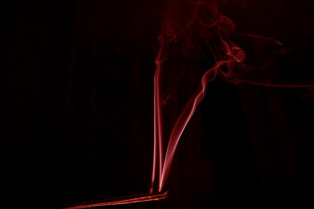 abstract red smoke on black background, red ink backgroundの写真素材