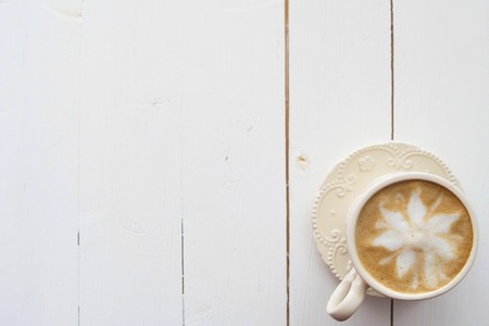 Coffee cup top view on wooden table backgroundの写真素材