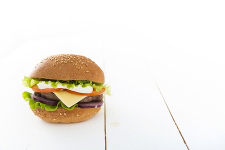 Tasty hamburger on the white wooden table.の写真素材