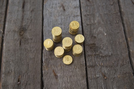 Pile of money coins on wooden tableの写真素材