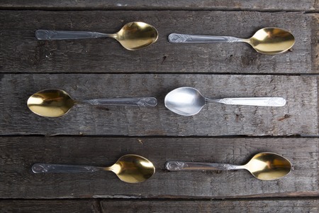 Vintage metal spoons on wooden tableの写真素材