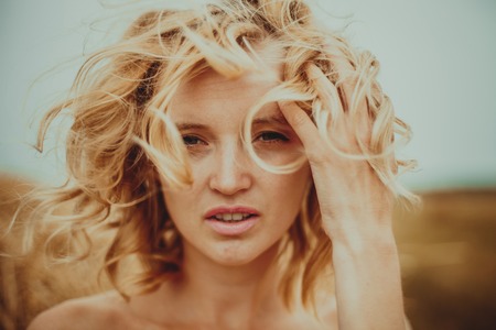 Gorgeous Girl Outdoors. Beautiful  Model in Field. Long Hair Blonde in the Wind.の写真素材