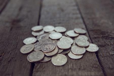american coins background on wooden table. quarter dollar. Cross Processing tone colored.の写真素材