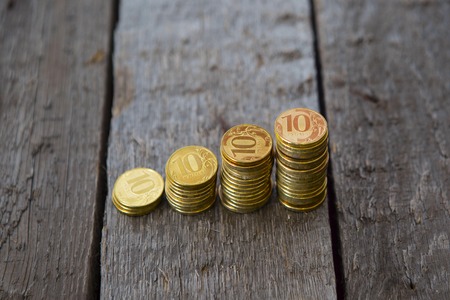 Graph from money coins on wooden tableの写真素材