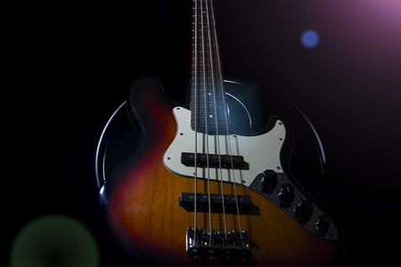 Bass guitar, musical instrument on black or dark backgroundの写真素材