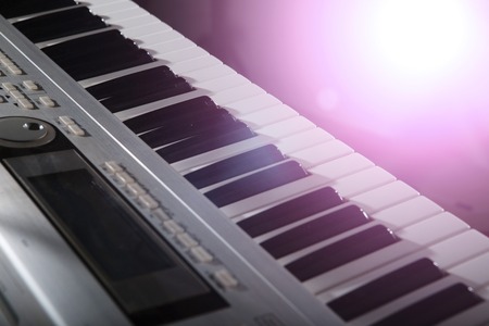 Piano keyboard background with selective focus. Warm color toned imageの写真素材