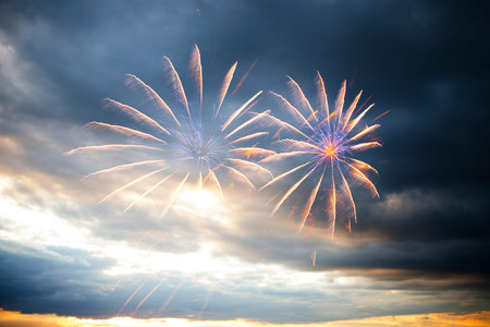 Colorful holiday fireworks in the evening sky with majestic clouds, long exposure