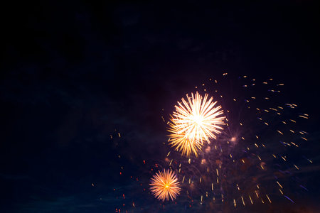 Fireworks in sky twilight. Fireworks display on dark sky background. Independence Day, 4th of July,...