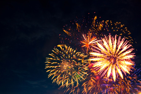 Fireworks light up the sky with dazzling display. Fireworks display on dark sky background. Independence Day, 4th of July, Fourth of July or New Year.の写真素材