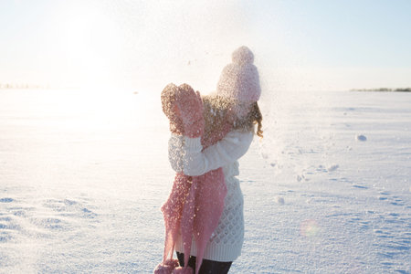Beautiful and sexy woman in snowy winter outdoors. Sunny weather. Outdoor shot.の写真素材