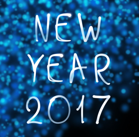 Happy new year 2017 on snowflakes background. Happy new year 2017 written with neon light.