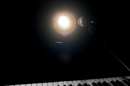 Microphone and piano in the dark background. Music and concert concept.の写真素材