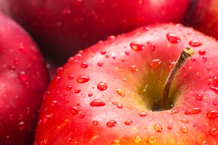 Macro of fresh red wet apples with water drops. Healthy eating.の写真素材