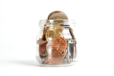 Mason Jar with Coins Isolated on Whiteの写真素材