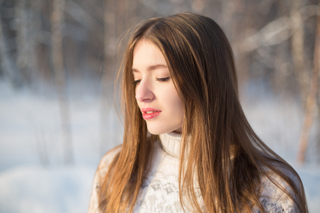 Winter portrait of a beautiful brunette. Joyful Beauty young woman Having Fun in Winter Park.の写真素材