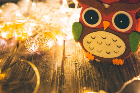 Christmas fairy lights on a wooden table to be used as background or texture.の写真素材