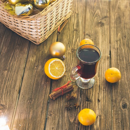 Still life, food and drink, seasonal and holidays concept. Christmas mulled wine on a rustic wooden table. Christmas mulled wine with spices and fruits on dark wooden table.の写真素材