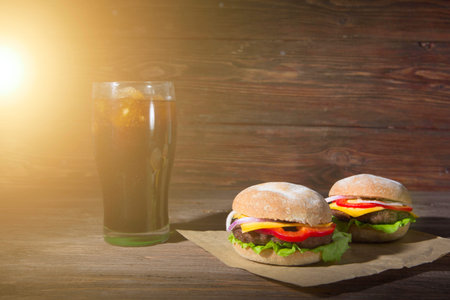 Homemade burger and Cold drink cola on wooden surface backgroundの写真素材