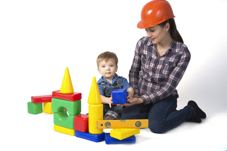 Kd boy and mother play together with construction set toy isolated on white backgroundの写真素材