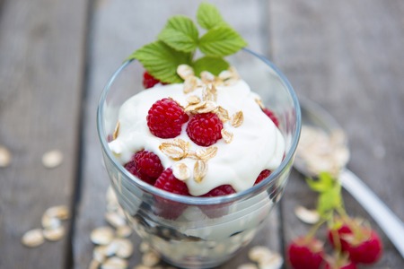 Healthy yogurt dessert raspberry mousse and black currants on a wooden table.の写真素材