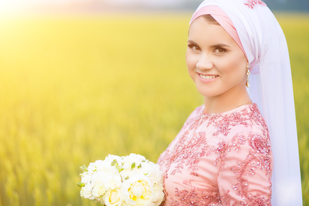 Beautiful young oriental bride preparing for wedding. Muslim marriage.の写真素材