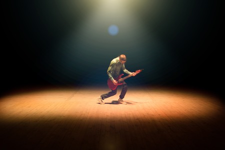 Guitarist musician guitar electric playing on dark background.の写真素材