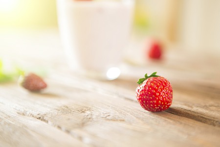 Strawberry close-up on rustic wooden table with yoghurt.の写真素材