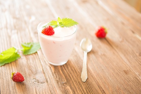 Fresh strawberry yoghurt on rustic wooden table.の写真素材