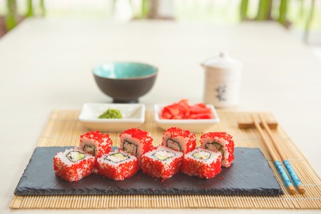 Sushi rolls on black slate surface. Japanese food.の写真素材