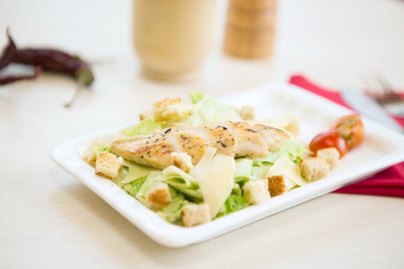 Homemade Vegetable salad with chicken and cheese on table.の写真素材