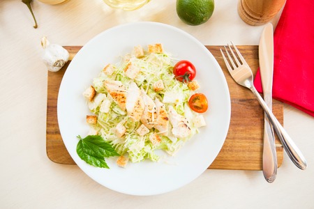 Caesar Salad with chicken and cheese on a table.の写真素材