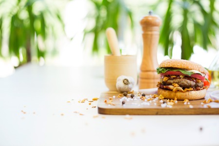 Fast food concept. Homemade burger on a wooden table.の写真素材