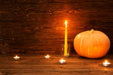 Happy Thanksgiving Day background, wooden table with Pumpkins and Candles.の写真素材