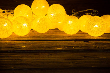 Christmas lights background on old wood textured background.の写真素材